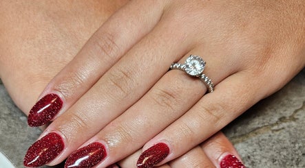 Elegant red sparkly nails with ring at Nailed it Nails, Waupun, Wisconsin, US.