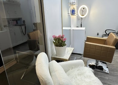 Inside Lucas Hair Loft in Tampa, Florida, US, featuring stylish chairs and a cozy, elegant setting.