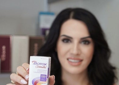 A smiling professional holds Botox at Niagara Medical Esthethics, Niagara Falls, Ontario, CA.