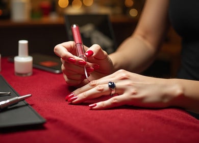 Nail technician applying polish at GlanzNägel in Berlin, Berlin, DE.