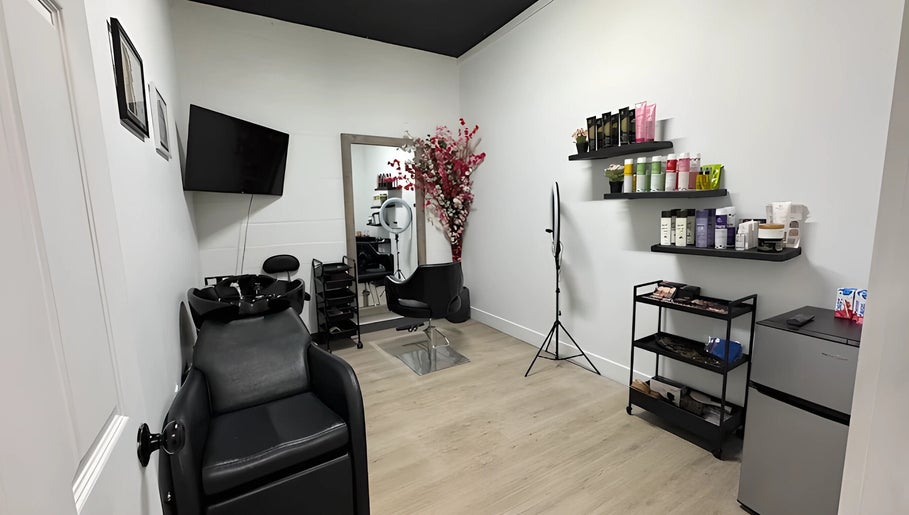 Modern interior of Mango Hair Studio in Toronto, Ontario, CA showcasing sleek styling station and products.
