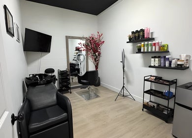 Modern interior of Mango Hair Studio in Toronto, Ontario, CA showcasing sleek styling station and products.