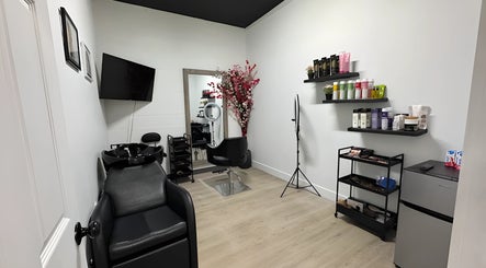 Modern interior of Mango Hair Studio in Toronto, Ontario, CA showcasing sleek styling station and products.