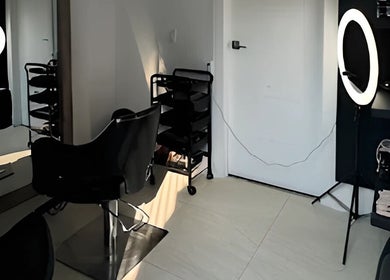 Modern hair styling station at Mango Hair Studio in Toronto, Ontario, CA, featuring sleek chairs and professional lighting.