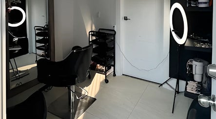 Modern hair styling station at Mango Hair Studio in Toronto, Ontario, CA, featuring sleek chairs and professional lighting.