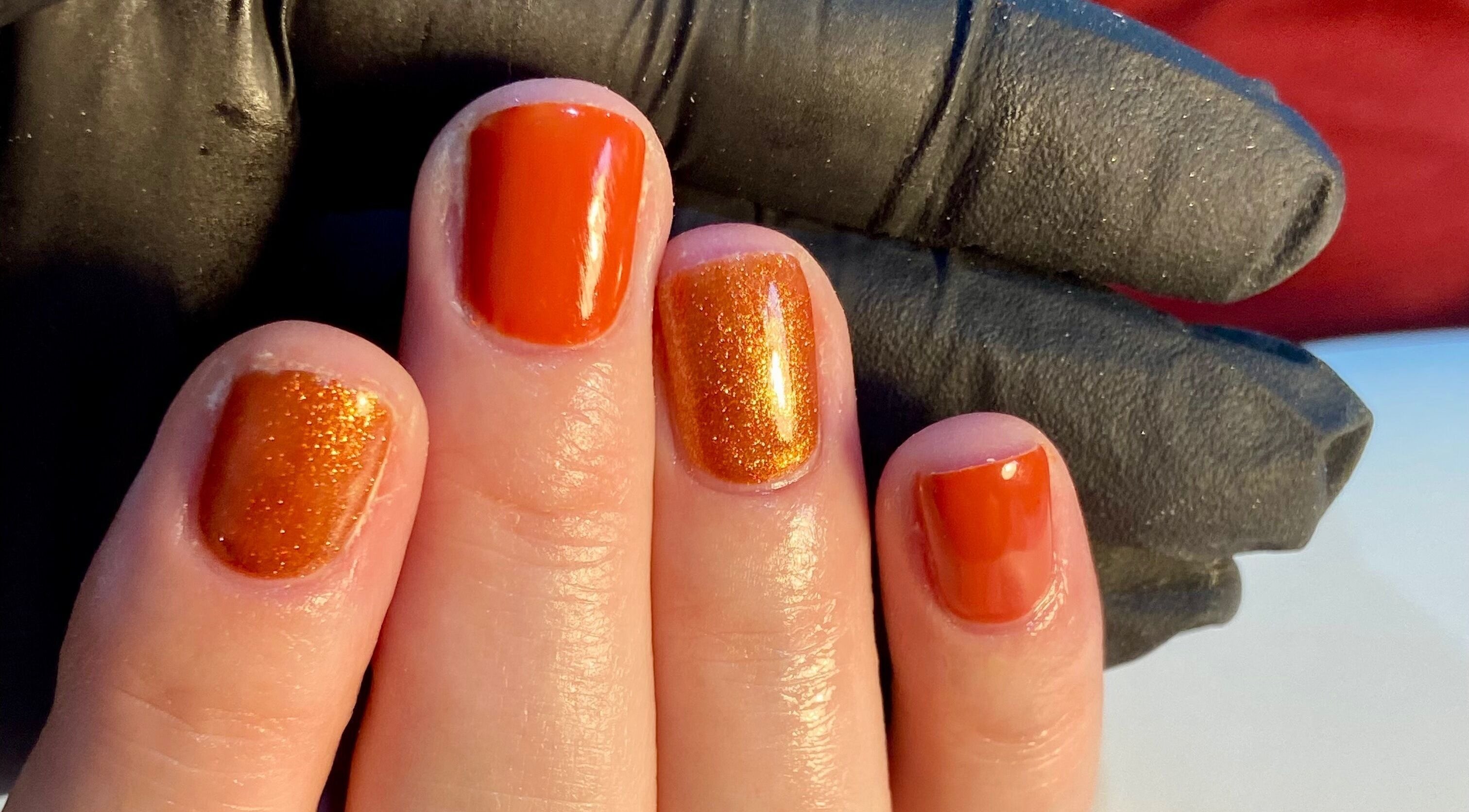 Orange glitter manicure at Nails By Ava, Bridgwater, England, GB, highlighting vibrant nail art.