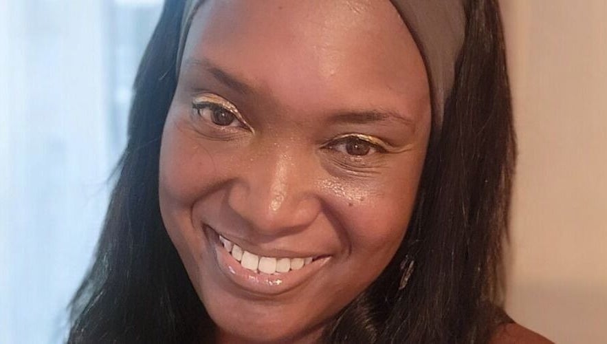 Smiling woman at Life Story Coach By Jenni, Birmingham, England, GB, embracing joy and wellness.
