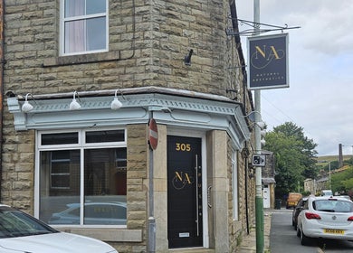 Exterior of Alana Fores Nails and Makeup in Shawforth, England. A welcoming stone facade with signage.