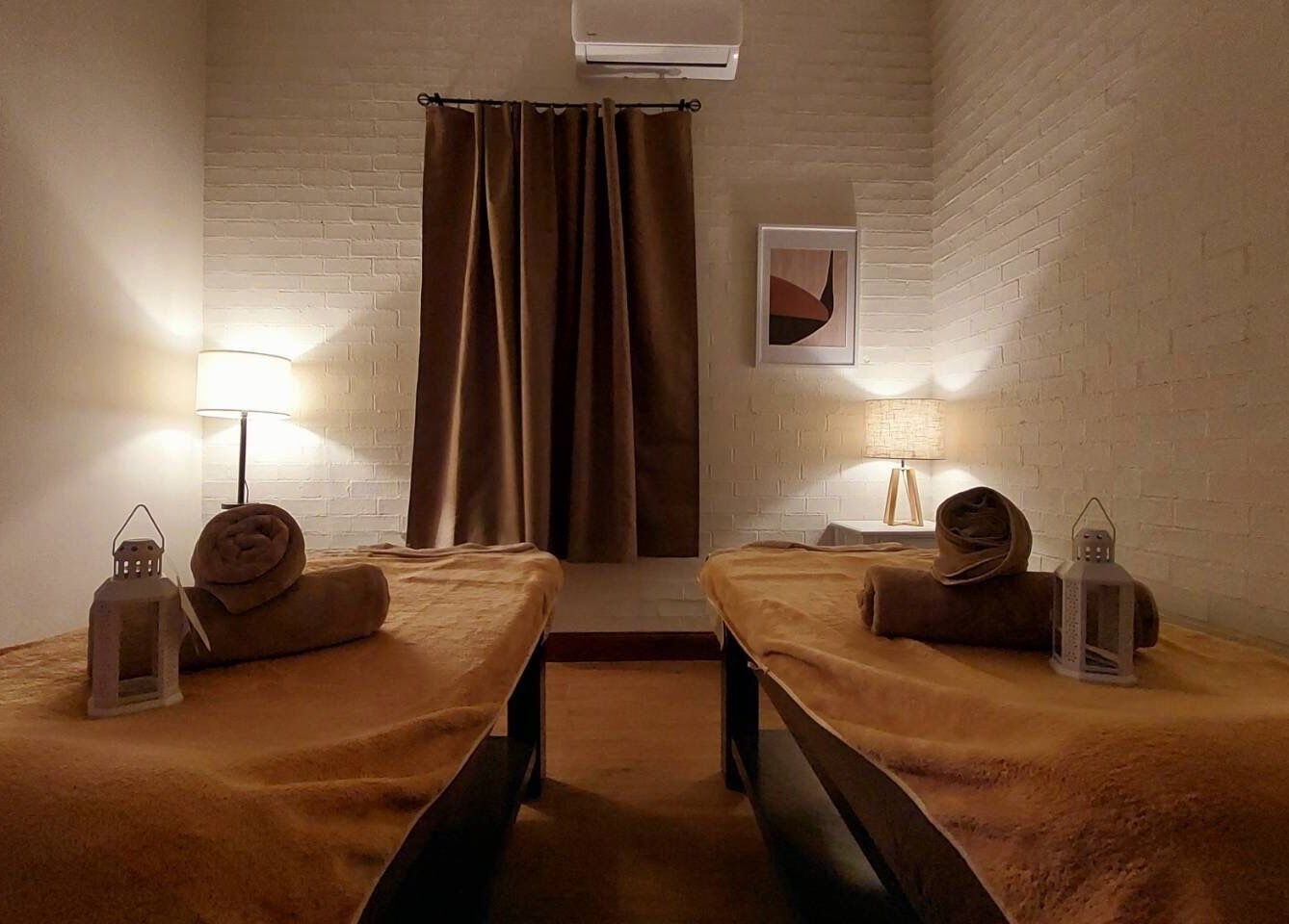 Cozy massage room at Aya Haus Massage & Day Spa, Shellharbour, New South Wales, AU with warm lighting and twin tables.