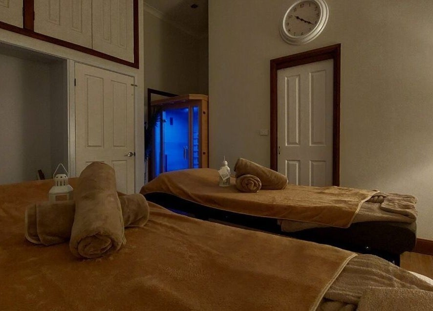 Relaxing massage room at Aya Haus Massage & Day Spa in Shellharbour, New South Wales, AU, with soft lighting.