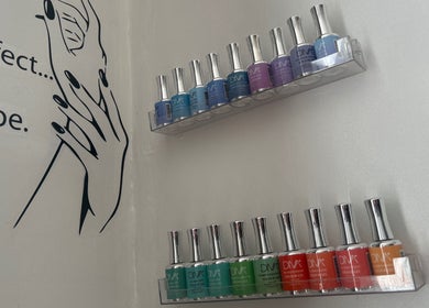 Nail polish display at Luxe Beauty Lounge, Coventry, England, GB enhances salon's elegant ambiance.