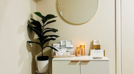 Modern decor corner at Beautique Smiles, Dunlop, AU featuring a plant and golden accents.