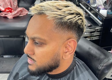 Modern haircut at trimgudbyhadi in Luton, England, GB. Close-up of styled hair with barber chair.