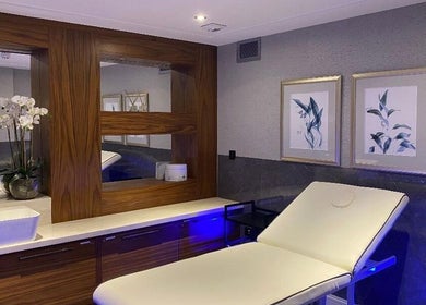 Relaxing treatment room at London & Surrey Aesthetics, London, England, GB showcasing elegant decor and modern facilities.