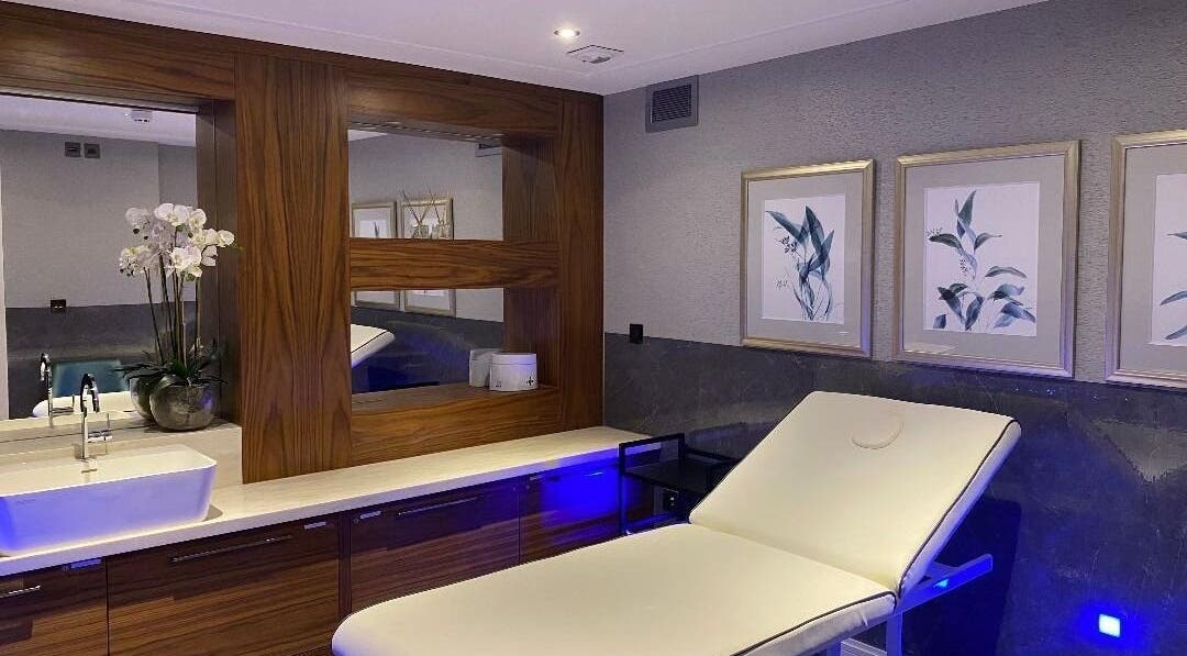 Relaxing treatment room at London & Surrey Aesthetics, London, England, GB showcasing elegant decor and modern facilities.