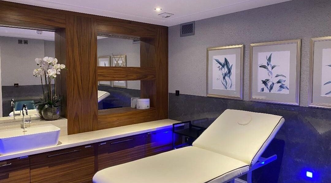 Relaxing treatment room at London & Surrey Aesthetics, London, England, GB showcasing elegant decor and modern facilities.