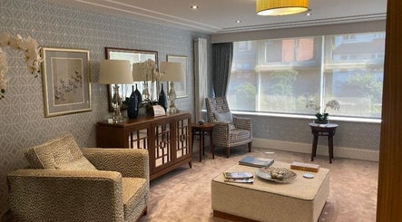 Sophisticated seating area at London & Surrey Aesthetics, London, England, GB with chic decor and natural light.
