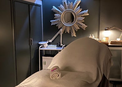 Relaxing treatment room at Crystal Palace, London, England, GB with spa bed and decorative mirror.