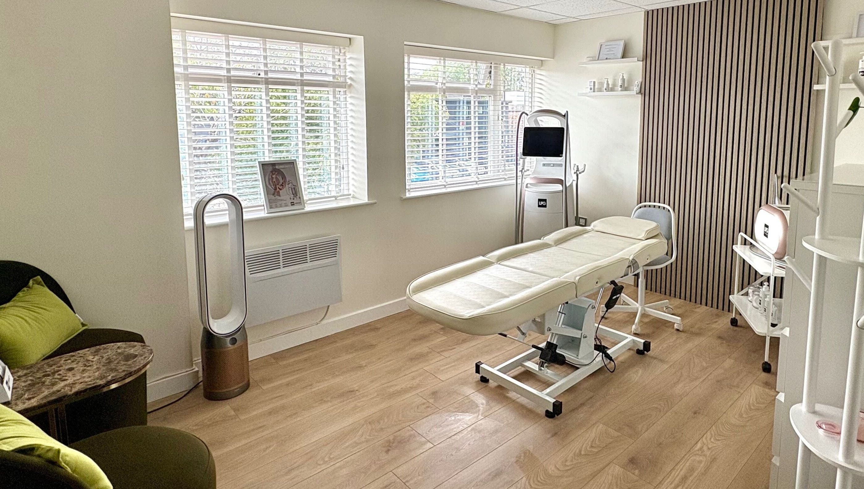 Relaxing treatment room at Daniva Wellness, Cuffley, GB, with massage table and soothing decor.