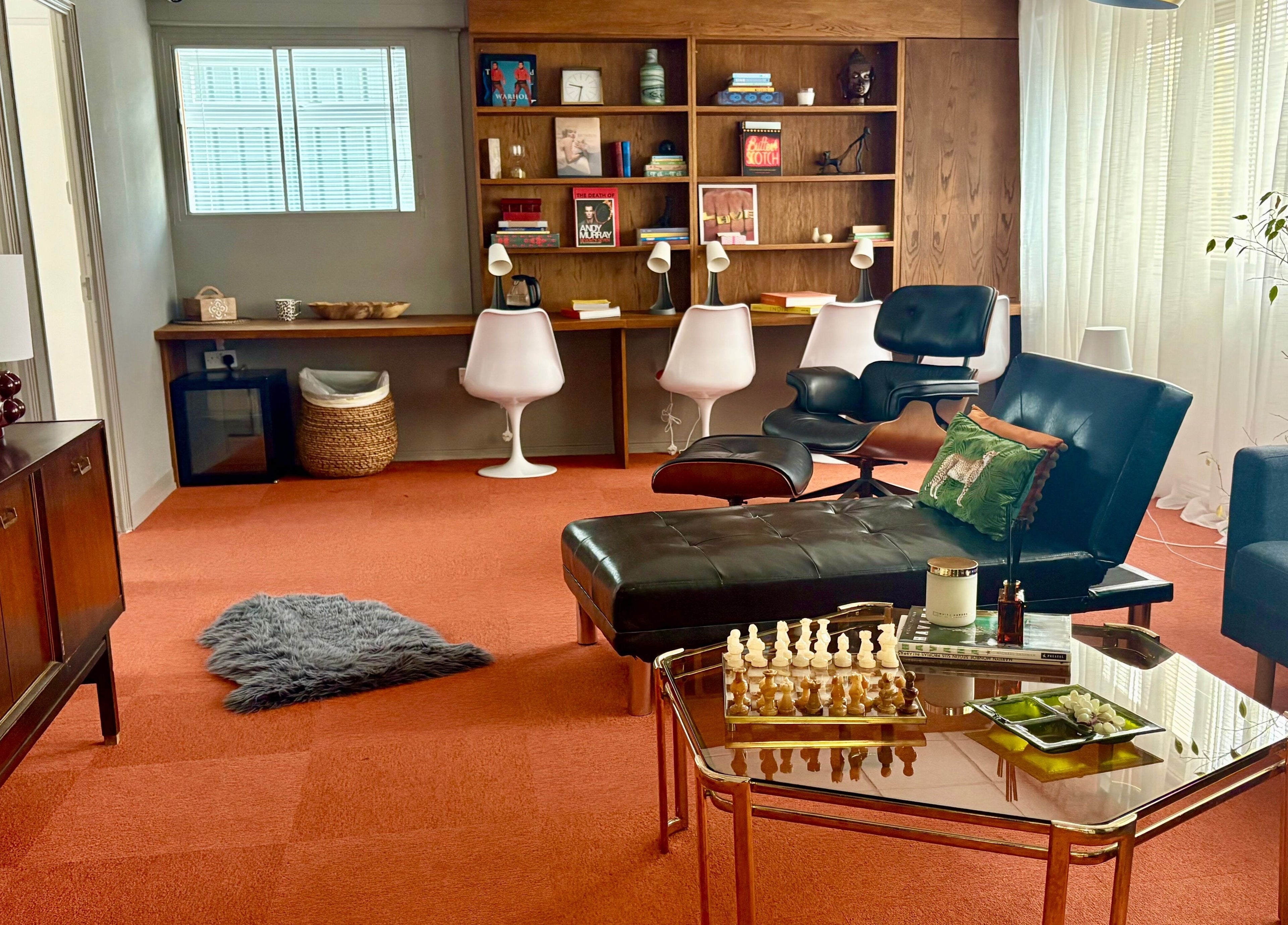 Inviting lounge at Daniva Wellness, Cuffley, GB, featuring stylish furniture and a chessboard on a coffee table.