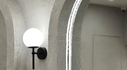 Modern wall light fixture at Maryané Beauté, Darlinghurst, New South Wales, AU, highlighting minimalist elegance.
