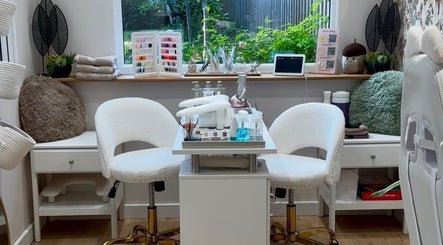 Aurora Beauty Studio in Newton Poppleford, England, GB showcases a modern nail station with white chairs and beauty products.