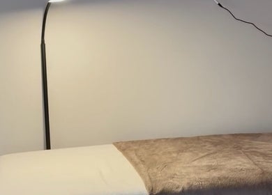 Cozy massage bed under soft lighting at Aurora Beauty Studio, Newton Poppleford, England, GB.