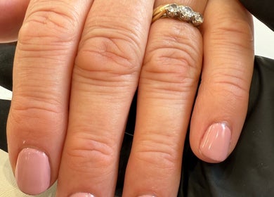 Manicured hands with light pink nails at Aurora Beauty Studio, Newton Poppleford, England, GB.