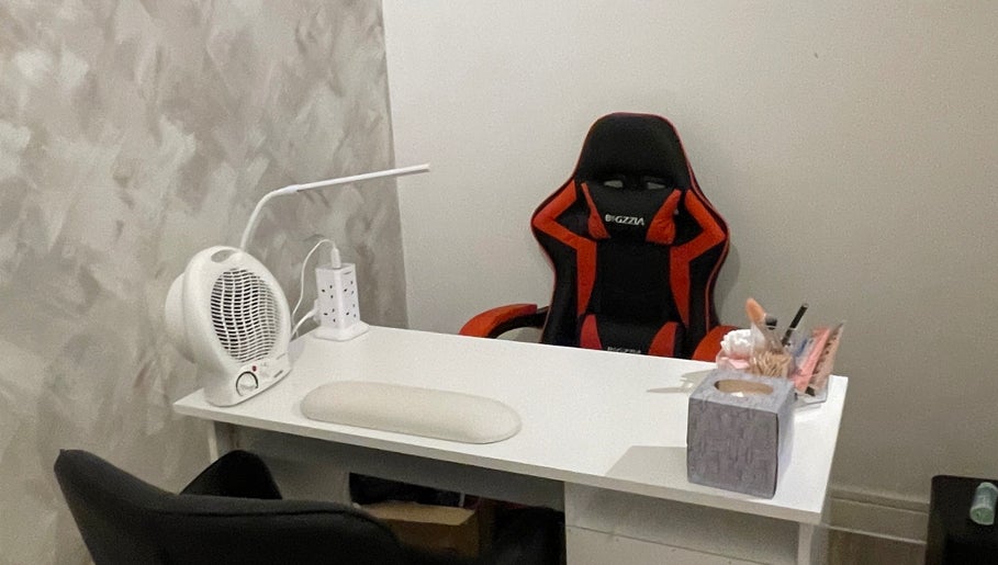 Cozy workspace at Charmed, Stafford, England, GB with a stylish chair and modern accessories.