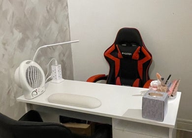 Cozy workspace at Charmed, Stafford, England, GB with a stylish chair and modern accessories.
