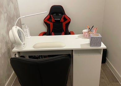 Modern salon workspace at Charmed in Stafford, England, GB featuring sleek chair and organized desk.
