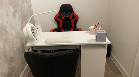 Modern salon workspace at Charmed in Stafford, England, GB featuring sleek chair and organized desk.