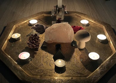 Tranquil candle and crystal arrangement at EyeAmHealing, Wolverhampton, England, GB on intricate brass tray.