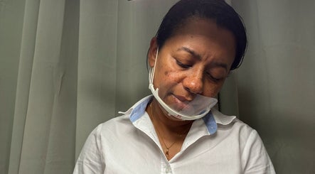 Profissional em KP Beauty, Póvoa De Varzim, Porto, PT, atende cliente com máscara protetora.