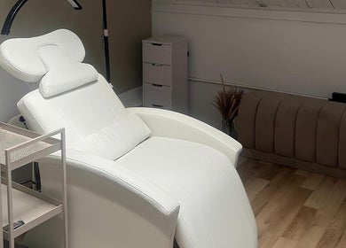 Elegant white treatment chair at ūme, London, England, GB, offering premium beauty and wellness services.