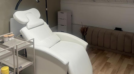 Elegant white treatment chair at ūme, London, England, GB, offering premium beauty and wellness services.
