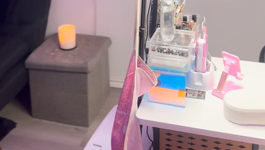 Cozy manicure setup at The Nail Bar by Cortni in La Marque, Texas, US with a candle and organized tools.