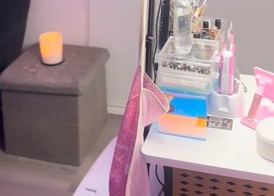 Cozy manicure setup at The Nail Bar by Cortni in La Marque, Texas, US with a candle and organized tools.