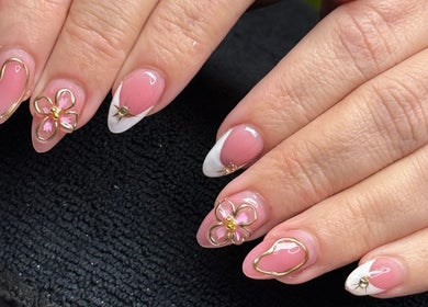 Elegant floral nail art at The Nail Bar by Cortni in La Marque, Texas, US featuring intricate pink and white designs.