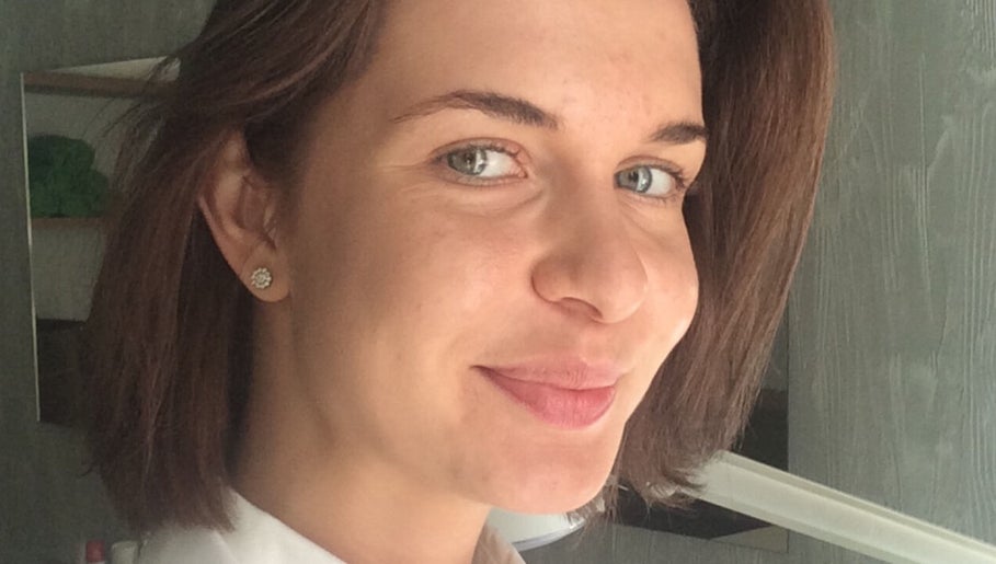 Smiling staff member at Cambridge Beautician. Romsey Town, Cambridge, England, GB.