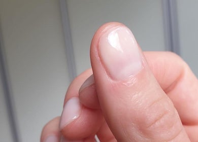 Close-up of a freshly manicured thumb at Cambridge Beautician. Romsey Town, Cambridge, England, GB.