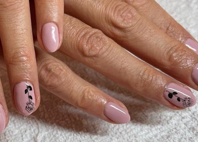 Beautiful pink gel nails with floral art at Cambridge Beautician, Romsey Town in Cambridge, England, GB.