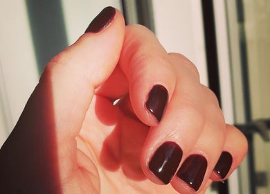 Elegant deep red manicured nails at Cambridge Beautician, Romsey Town, Cambridge, England, GB.