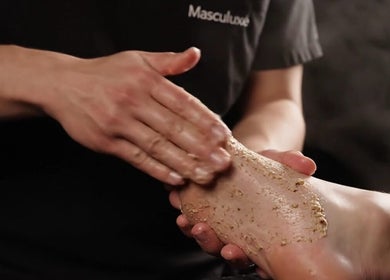A relaxing foot scrub at Masculuxe Barbershop and Spa, مسقط, محافظة مسقط, OM offers rejuvenation.