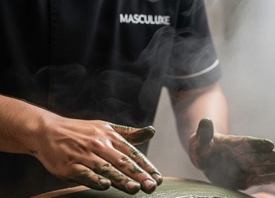 Therapist applying a soothing clay mask at Masculuxe Barbershop and Spa in مسقط, محافظة مسقط, OM.