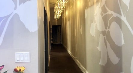 Stylish hallway with floral wall art at Massage One Wellness, South Pasadena, CA, US.
