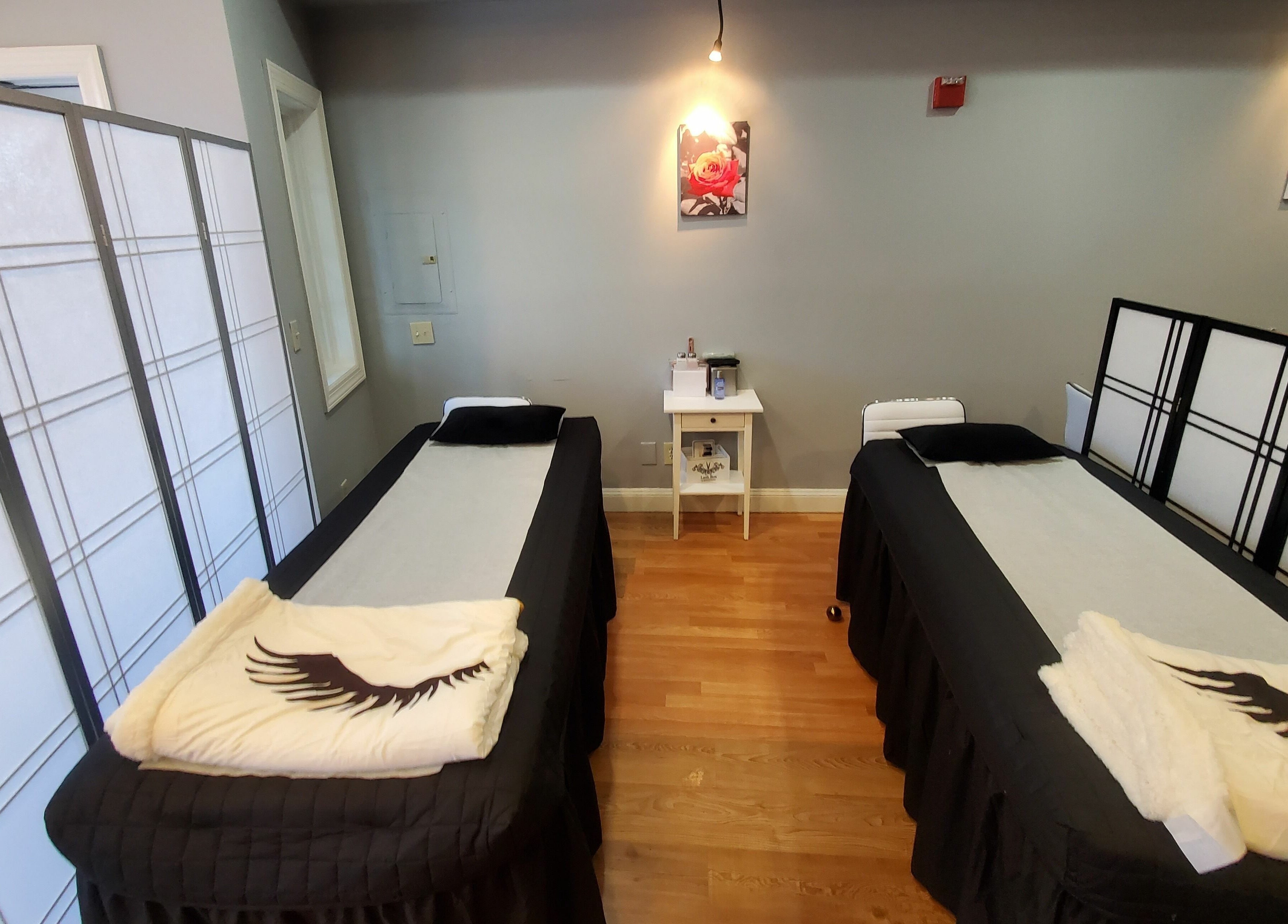 Relaxing treatment room with two beds at Gold Lash in Syosset, New York, US.