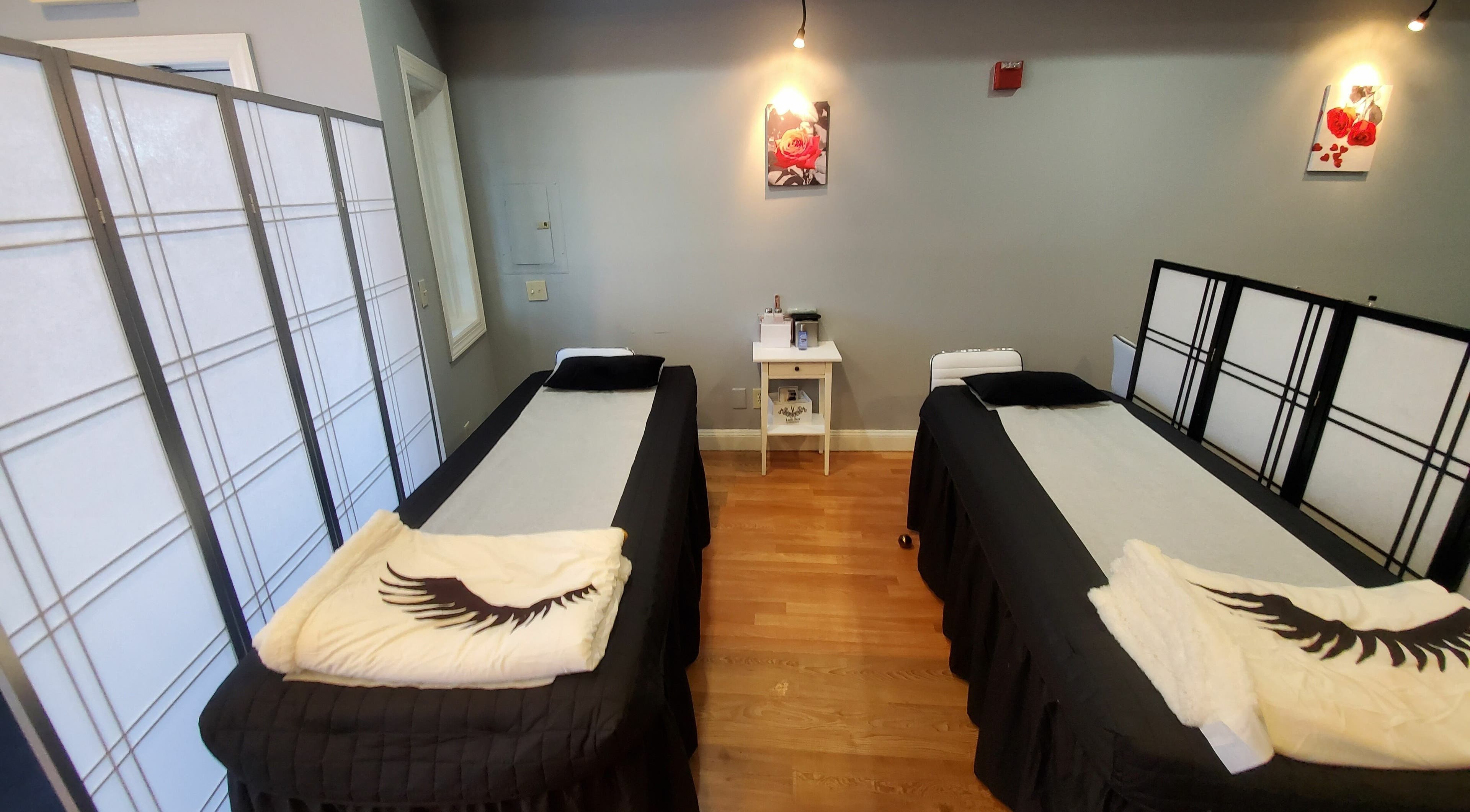 Relaxing treatment room with two beds at Gold Lash in Syosset, New York, US.