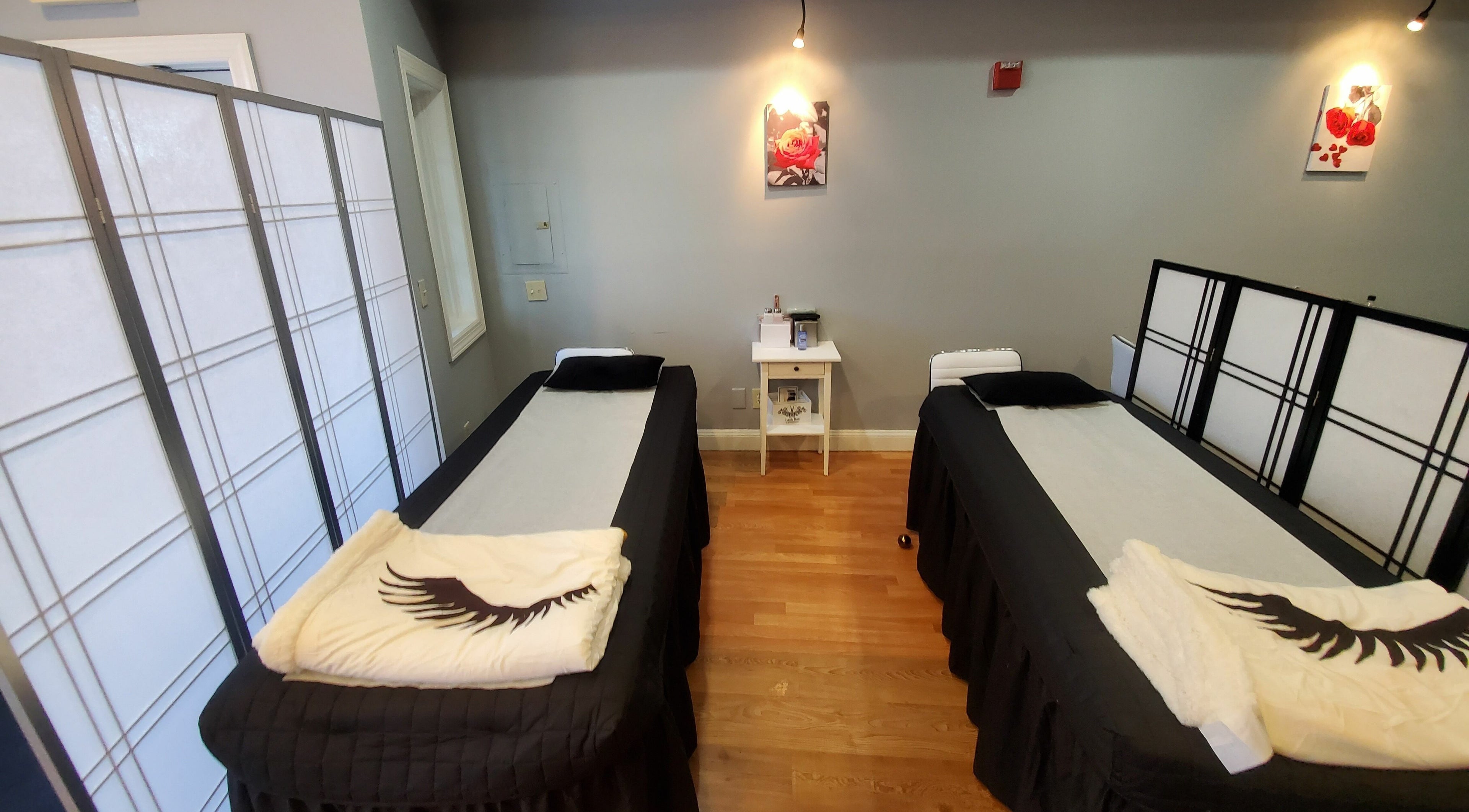 Relaxing treatment room with two beds at Gold Lash in Syosset, New York, US.
