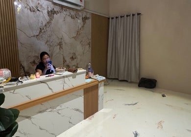 Reception desk at Enchanté House of Beauty, Petaling Jaya, Selangor, MY with elegant marble decor.